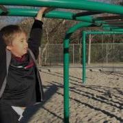 Instructing Kid How To Do The Monkey Bars