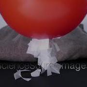 Demonstration Of Static Electricity A Balloon Rubbed On A Wool Sweater Picks Up Paper