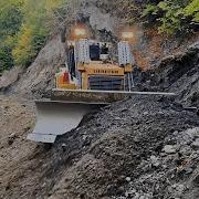 Skillful Excavator Operators Are Building Roads On A Steep Mountain