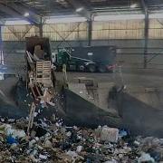 Garbage Trucks Dumping In Transfer Station Pit